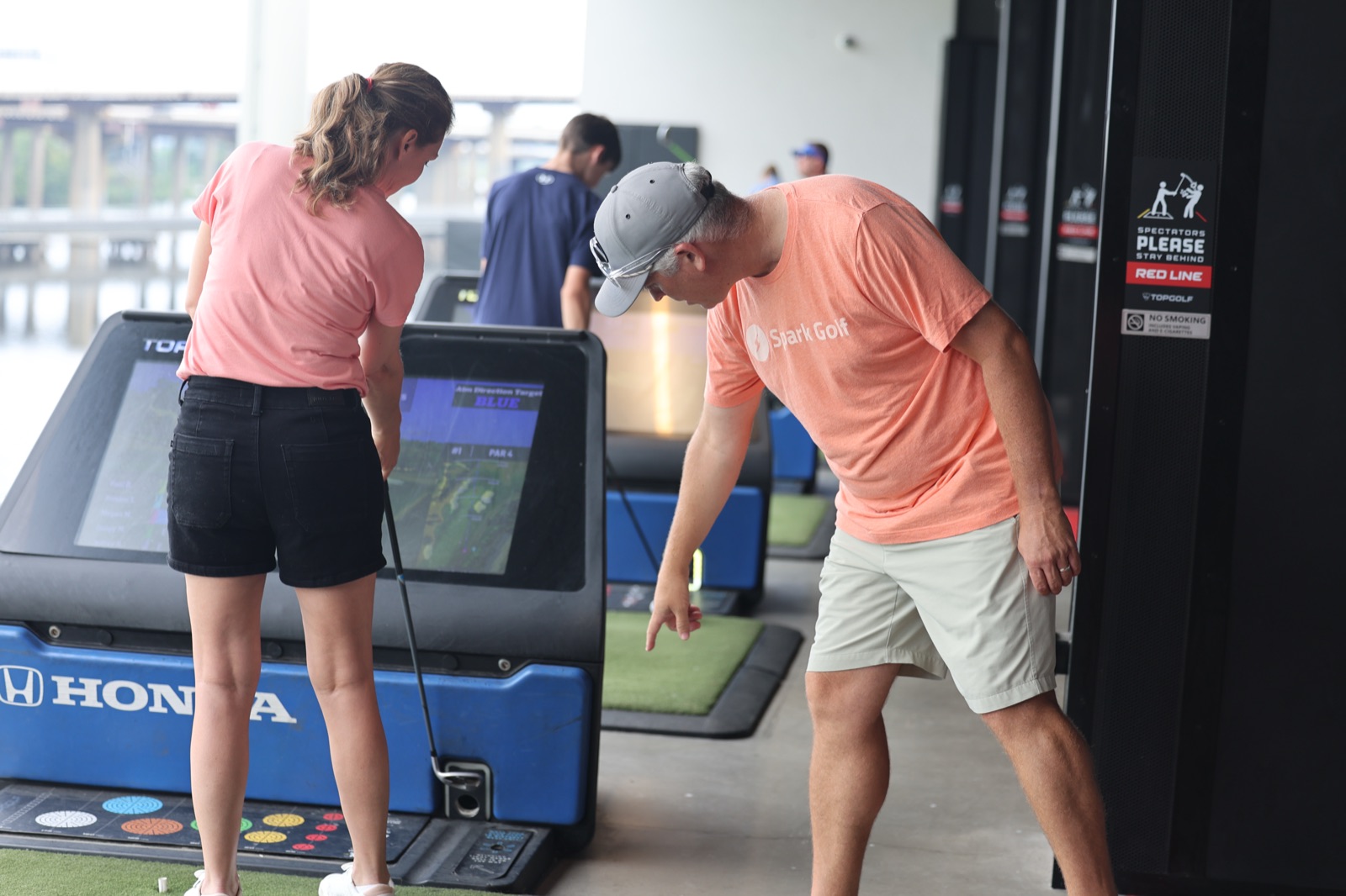 Spark golfers playing 9 virtual holes at Topgolf